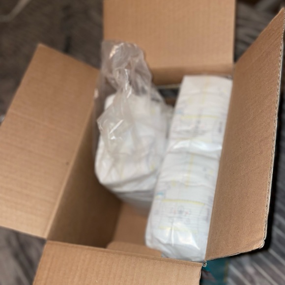 Diapers. Wipes. Assorted footies. FREE GIFT WITH PURCHASE - Picture 2 of 2